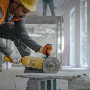 a man using a grinder on a piece of concrete