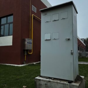 a white box sitting on top of a cement block
